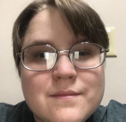 Close up portrait of valuableboy's face with short light brown hair  wearing oval shaped glasses