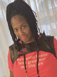 pretty brownskinned girl with high top loc ponytail in hot pink tee with leather harness vest and bright pink lipstick