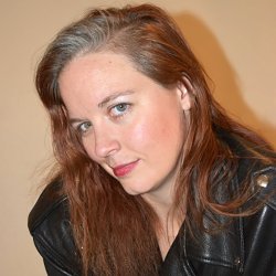 Pale skinned redhead in black leather jacket